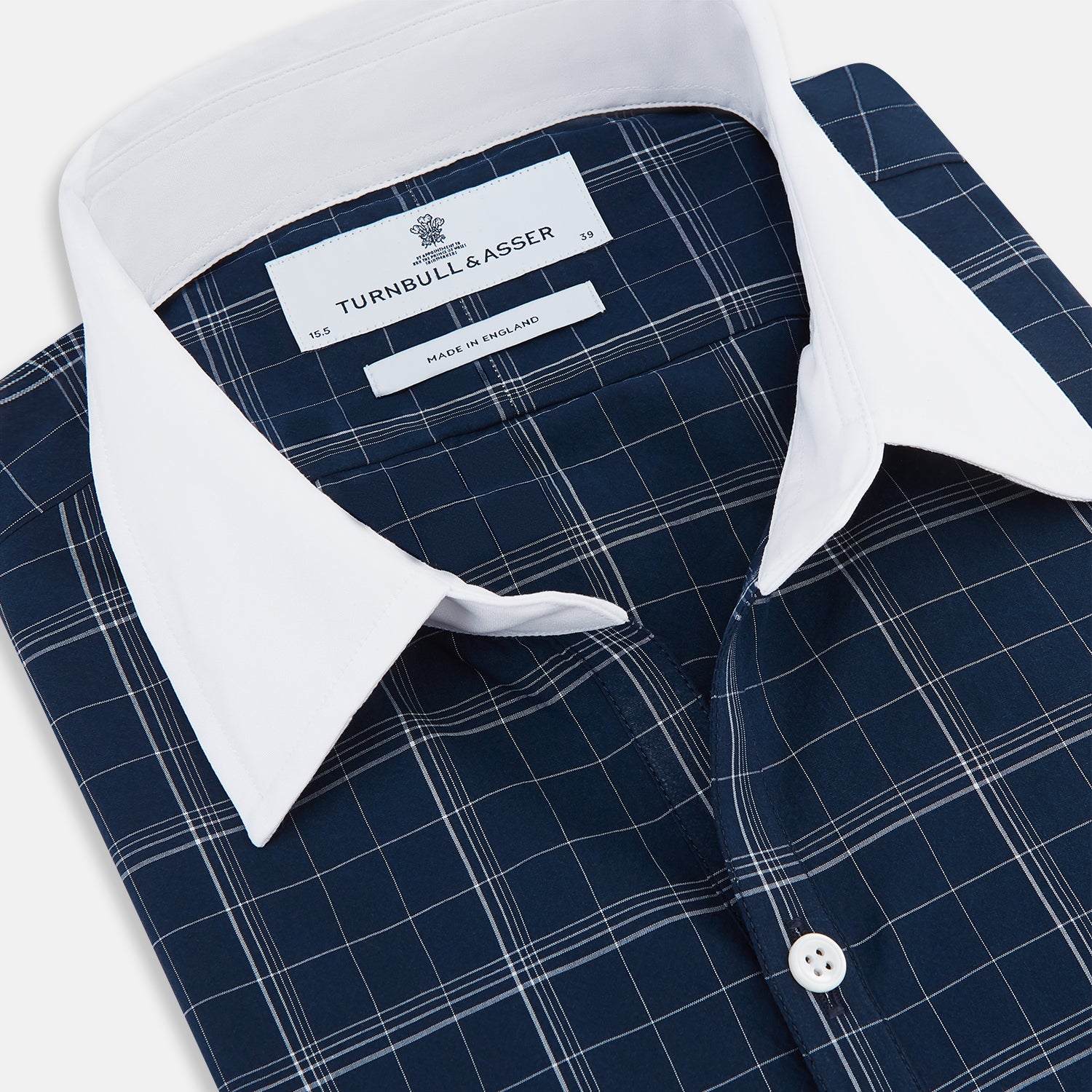 View 2 of product The Turnbull & Asser Indigo Windowpane Check Windsor Shirt features a contrast T&A collar and cuffs, highlighting British craftsmanship. It is displayed flat on a white background.