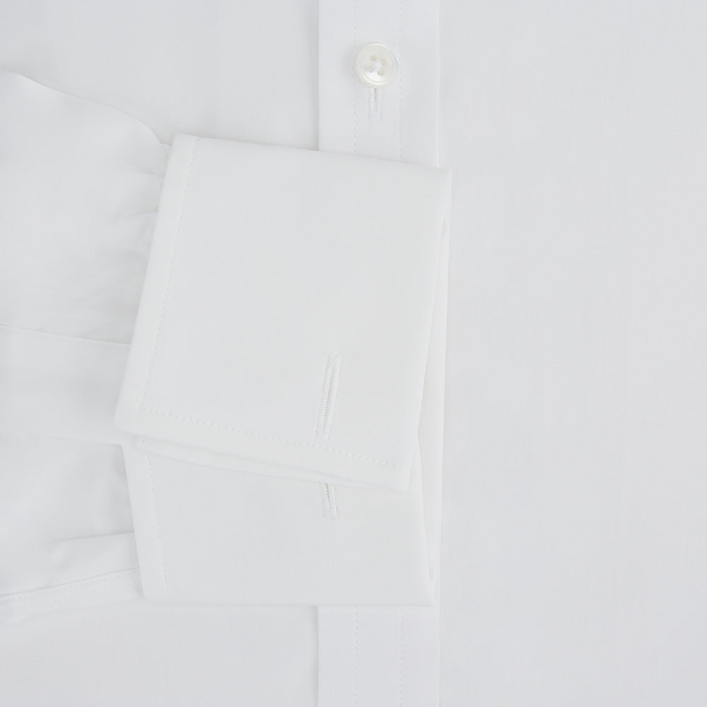 The Turnbull & Asser Plain White Cotton Shirt features a T&A collar and double cuffs, shown flat on a white background—ideal for pairing with standout ties or achieving a minimalist look.