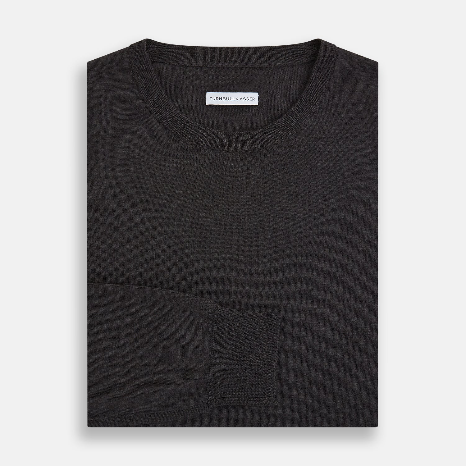 View 4 of product The Turnbull & Asser Charcoal Grey Fine Merino Round Neck Jumper for men features long sleeves, ribbed cuffs, hem, and collar. Displayed on a white background, this classic knitwear piece has a plain design with no visible logos or patterns.