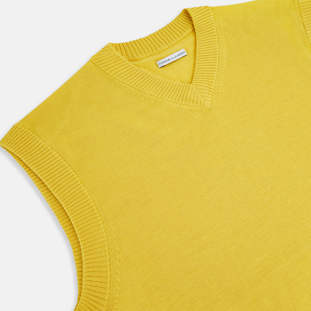 The Turnbull & Asser Canary Yellow Fine Merino V-Neck Vest is a sleeveless knit sweater with ribbed trim, adding elegance to any gentleman's outfit. Shown here on a plain white background.