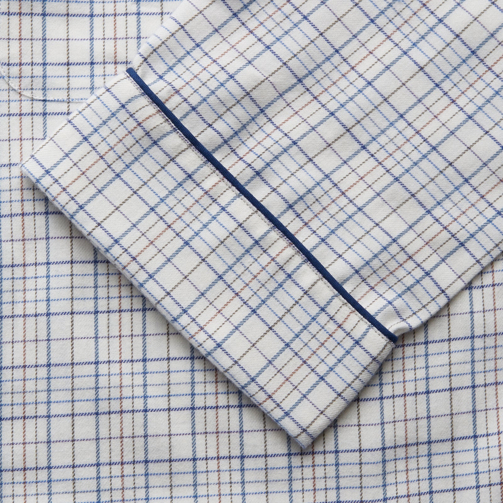 View 3 of product The Turnbull & Asser Blue Multi Check Cotton-Cashmere Modern Pyjama Set features a two-piece design with a long-sleeve button-up top with breast pocket and matching elastic-waist pants in a blue and white check pattern.