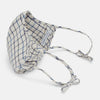 View 4 of product The Turnbull & Asser Check Blue Multi Commuter Mask features a blue plaid design, adjustable fabric ear loops tied in bows, and comes with 3 Viroformula™ filters. Laid flat on a white background.