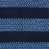 View 3 of product The Turnbull & Asser Navy and Blue Square tipped knitted tie features horizontal stripes and a rolled-up silk design, elegantly displayed on a plain white background.