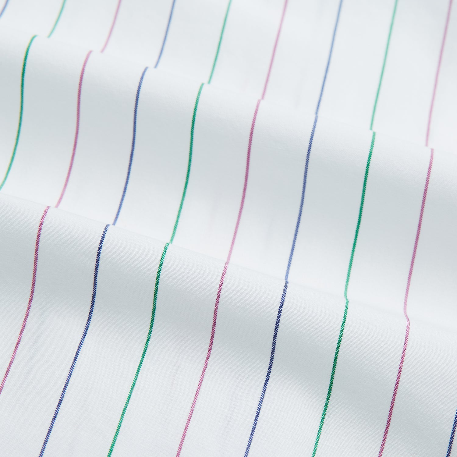 View 6 of product The Turnbull & Asser Pink and Green Wide Pinstripe Mayfair Shirt is a long-sleeve, button-up shirt made from organic cotton, shown laid flat on a white background.
