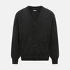 View 1 of product The Turnbull & Asser Dark Grey Melange Cashmere Cardigan features long sleeves, ribbed cuffs and hem, and two front pockets, shown on a plain white background.