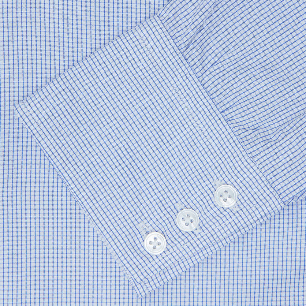 A neatly folded Turnbull & Asser Blue Grid Check Shirt features a T&A collar, 3-button cuffs, white buttons, and subtle British style. The blue and white check cotton design displays the brand label inside the collar.