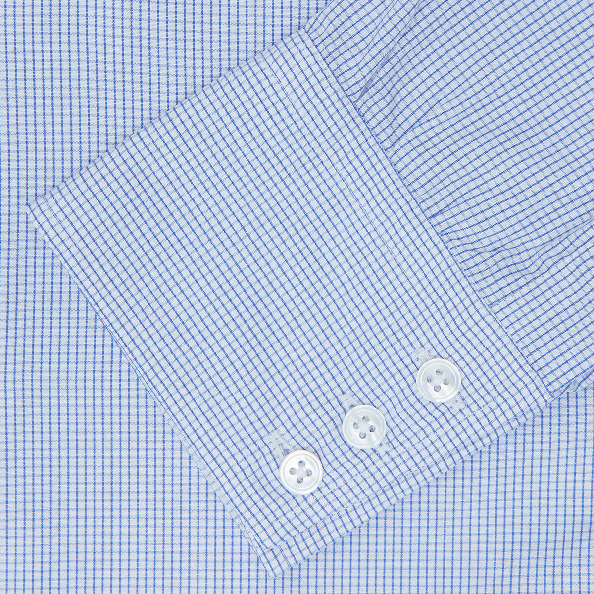 View 3 of product A neatly folded Turnbull & Asser Blue Grid Check Shirt features a T&A collar, 3-button cuffs, white buttons, and subtle British style. The blue and white check cotton design displays the brand label inside the collar.