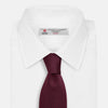 View 2 of product The HOUNDSTOOTH NAVY BURGUNDY TIE by Turnbull & Asser features a textured navy and burgundy silk woven pattern—an elegant staple for every gentleman’s wardrobe.