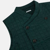 View 2 of product The Turnbull & Asser Forest Green Double-Breasted Quilted Gilet features black buttons, a chest pocket, two zippered side pockets, and an overlapping collar—ideal for layered dressing against a plain white background.
