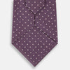 View 3 of product The Turnbull & Asser Lilac and Purple Micro Dot Silk Tie, featuring small white dots, is a stylish accessory for smart attire. Displayed rolled-up on a light background.
