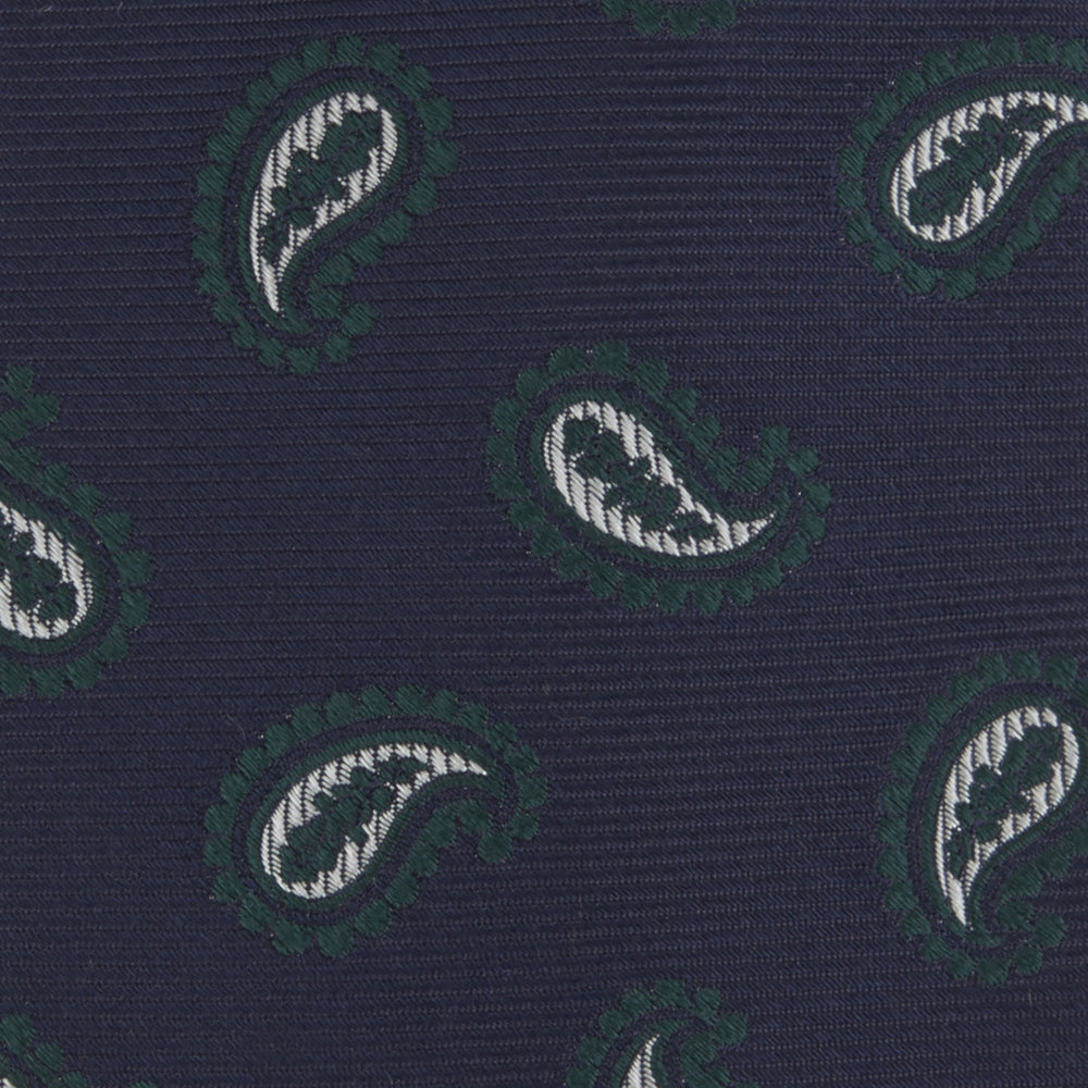The Turnbull & Asser Navy and Forest Green Floating Paisley Silk Tie features a green and white paisley pattern, elegantly rolled up for a stylish presentation.