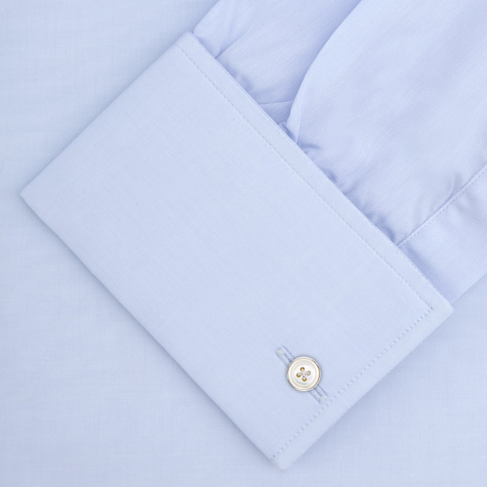 A neatly folded Turnbull & Asser Two-Fold 120 Light Blue Shirt, featuring a regent collar and double cuffs, is displayed against a plain white background.
