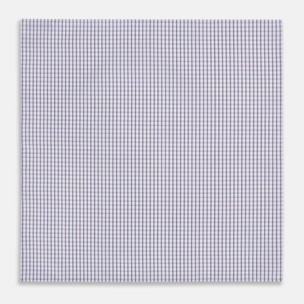 The Turnbull & Asser Purple Micro Shadow Check Hand-Rolled Handkerchief, crafted in England, features a checkered purple and white pattern with fine hand-rolled edges.
