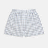 View 1 of product Turnbull & Asser's Blue Multi Graph Check Godfrey Boxer Shorts for men in Italian cotton feature a white base with a blue and black plaid pattern, shown flat against a plain white background.