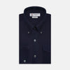 View 1 of product The Turnbull & Asser Navy Cashmere Cotton Shirt is a formal, dark navy blue shirt with a collar and front pocket, crafted from a luxurious cotton and cashmere blend, shown neatly folded against a white background.