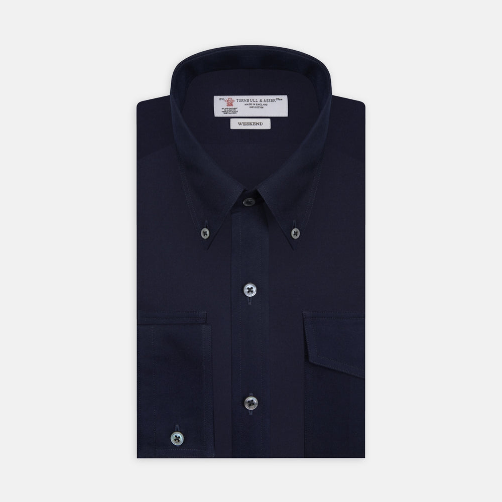The Turnbull & Asser Navy Cashmere Cotton Shirt is a formal, dark navy blue shirt with a collar and front pocket, crafted from a luxurious cotton and cashmere blend, shown neatly folded against a white background.