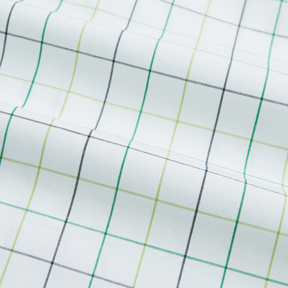 The Turnbull & Asser Dark Green Grid Check Mayfair Shirt features a white base with blue and dark green checks, a classic T&A collar, buttoned cuffs, and a Mayfair fit. The long-sleeve shirt is shown laid flat on a white background.