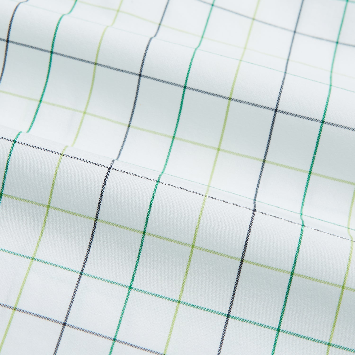 View 6 of product The Turnbull & Asser Dark Green Grid Check Mayfair Shirt features a white base with blue and dark green checks, a classic T&A collar, buttoned cuffs, and a Mayfair fit. The long-sleeve shirt is shown laid flat on a white background.