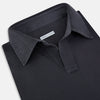 View 2 of product The Charcoal Rugby Polo Shirt by Turnbull & Asser is a pure cotton, long-sleeve polo in charcoal grey, featuring a collared open V-neck with no buttons, displayed flat on a white background.