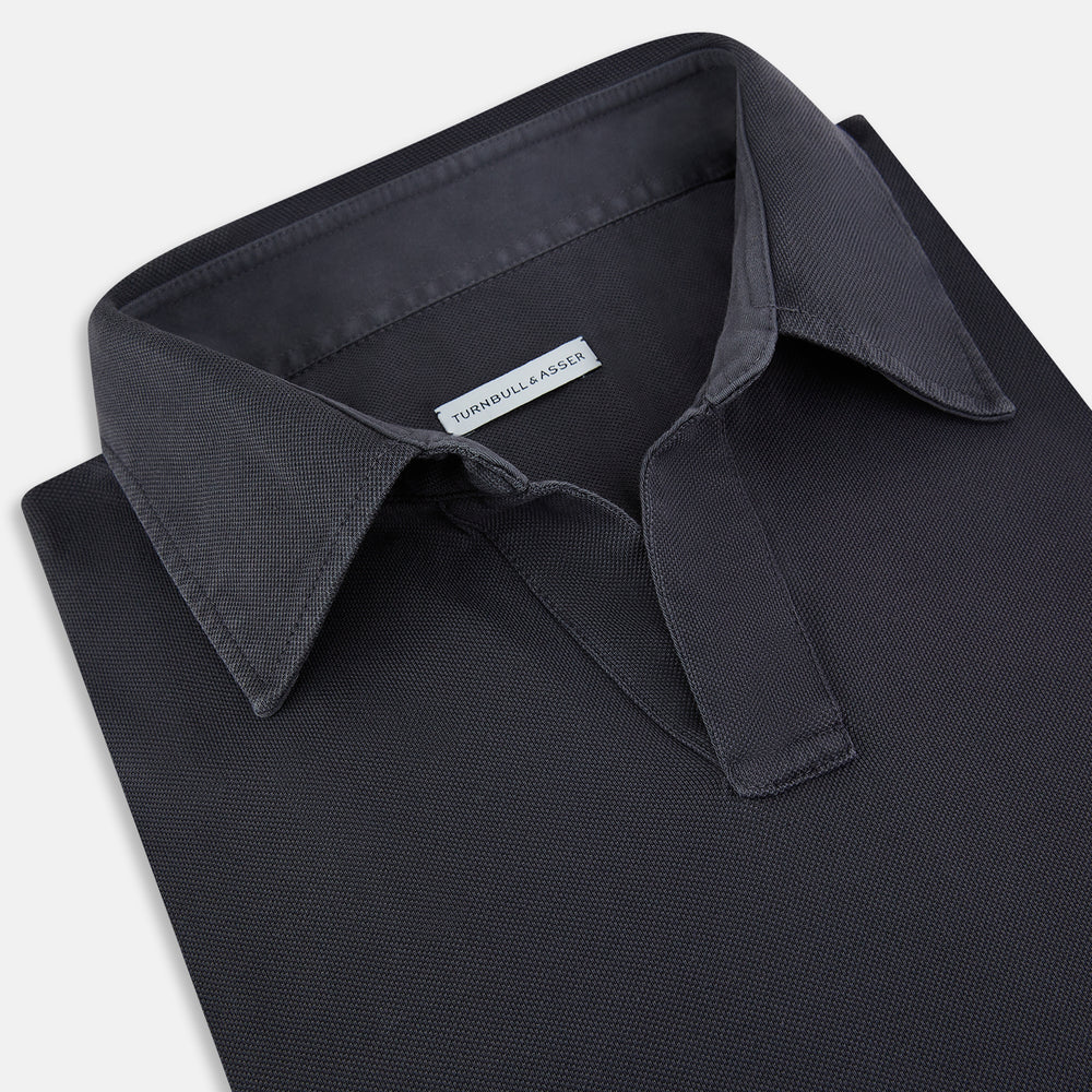 The Charcoal Rugby Polo Shirt by Turnbull & Asser is a pure cotton, long-sleeve polo in charcoal grey, featuring a collared open V-neck with no buttons, displayed flat on a white background.