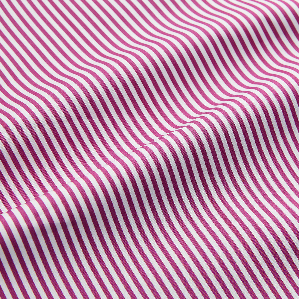 The Turnbull & Asser Purple & White Stripe Weekend Fit Shirt features a Derby collar, chest pocket, and 1-button cuffs—ideal for casual weekends.