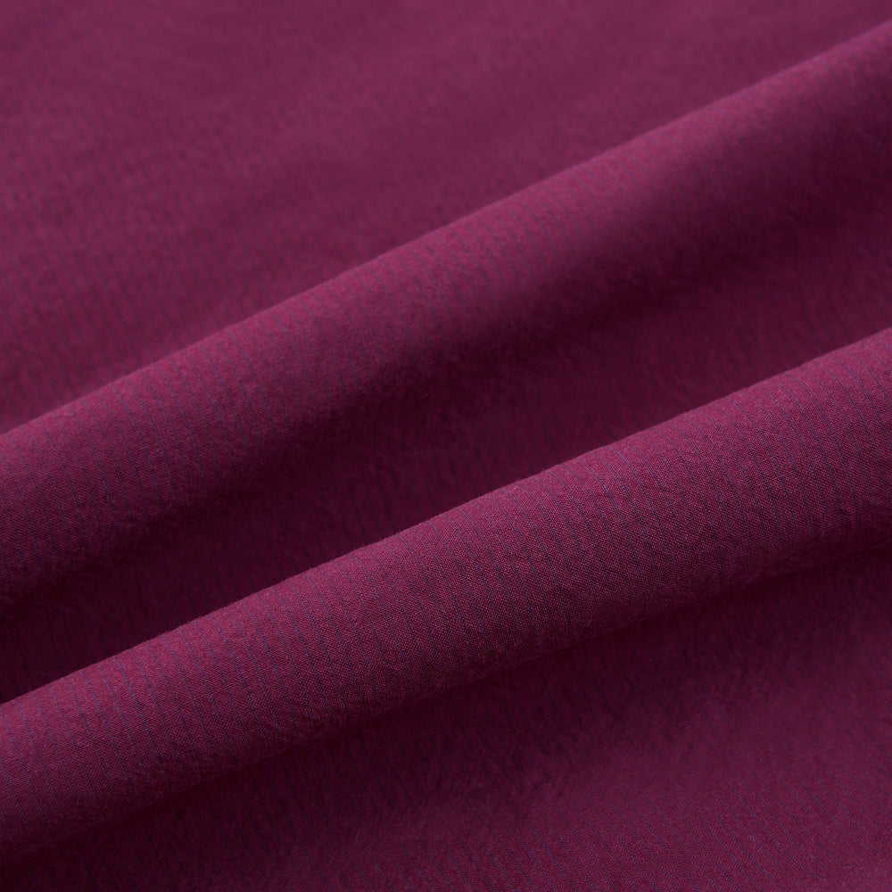 The Turnbull & Asser Wine Red Padded Gilet features a sleeveless design, front zipper, two zippered side pockets, a slanted chest pocket, and a rounded hem—perfect for the modern gentleman and shown on a plain white background.