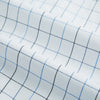 View 6 of product The Blue Grid Check Mayfair Shirt by Turnbull & Asser is a long-sleeve, button-up shirt with a T&A collar, crafted from organic cotton in a light and dark blue grid pattern, shown flat against a white background.