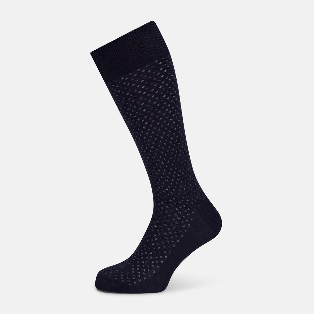 The Turnbull & Asser Midnight Motif Mid-Length Sock is a single black knee-high made from mercerised Egyptian cotton, featuring a subtle dotted pattern, showcased on a plain white background.