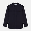 View 1 of product The Turnbull & Asser Navy Military Weekend Fit Shirt features a stand collar, black buttons, dual chest flap pockets, and 1-button cuffs in Italian cotton-wool, shown laid flat on a white background.