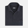 View 4 of product The Turnbull & Asser Charcoal Polo Shirt is a short-sleeve, soft cotton jersey top with a collar, three-button placket, and a left chest pocket, shown on a plain white background.