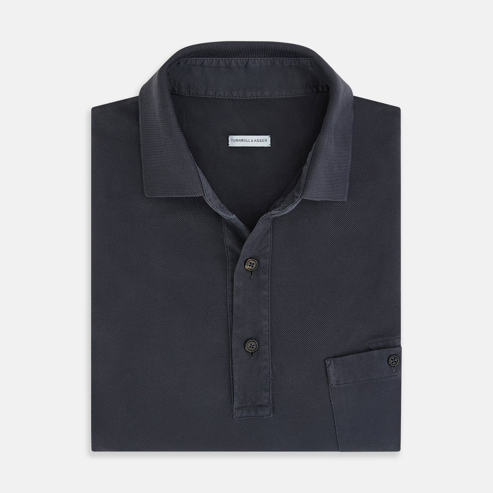 The Turnbull & Asser Charcoal Polo Shirt is a short-sleeve, soft cotton jersey top with a collar, three-button placket, and a left chest pocket, shown on a plain white background.