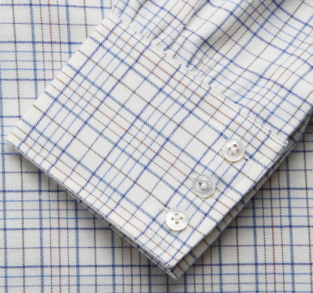 The Turnbull & Asser Blue Multi Check Regular Fit Cotton-Cashmere Shirt features a T&A collar, 3 button cuffs, and a white background with tonal blue and light brown checks—shown flat against a white background.