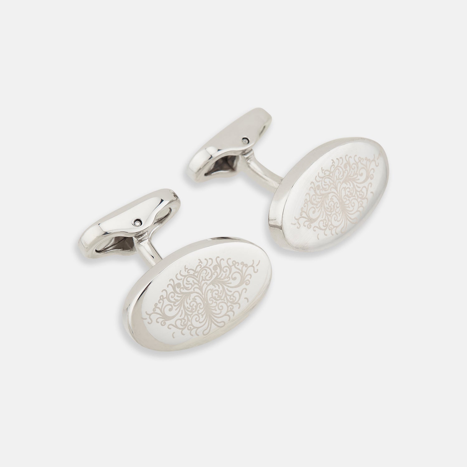 View 1 of product Turnbull & Asser Silver Antique Floral Oval Cufflinks feature engraved floral designs on oval faces, shown against a white background.