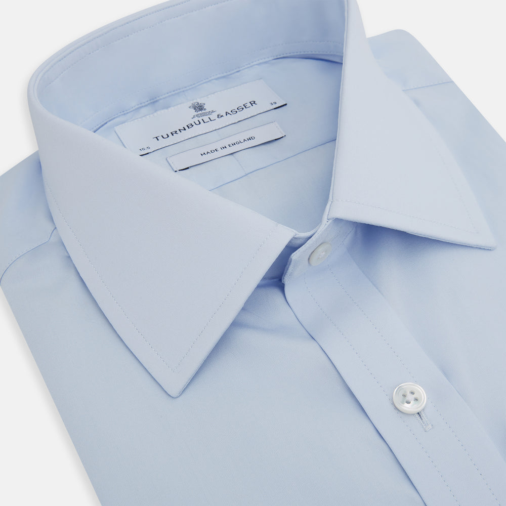 The Light Blue Mayfair Shirt by Turnbull & Asser is a men's cotton dress shirt featuring a pointed collar and button-down front, shown flat on a white background.