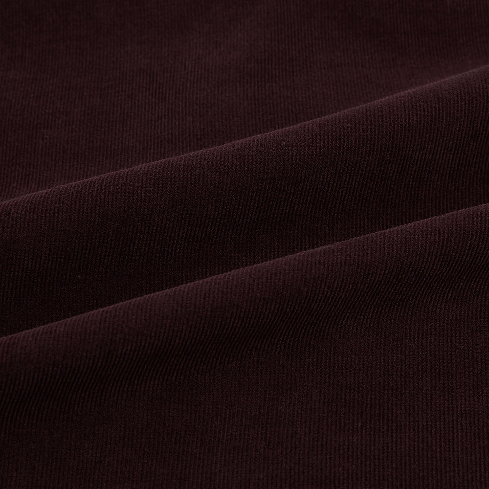 The Turnbull & Asser Burgundy Corduroy Hampstead Overshirt features long sleeves, a collar, a large left chest pocket, and two zippered side pockets, shown laid flat on a plain white background.