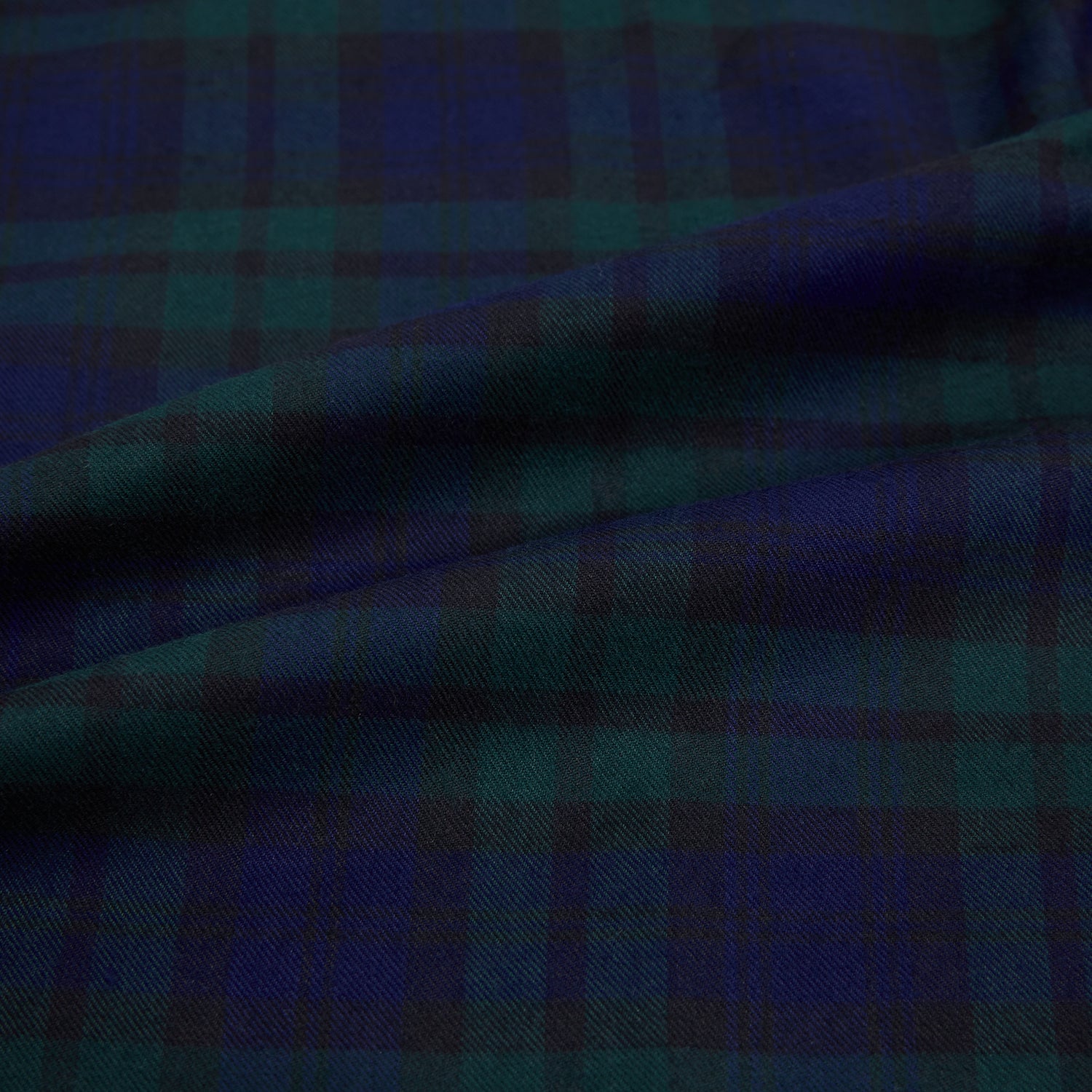 View 8 of product The Turnbull & Asser Black Watch Tartan Windsor Shirt is a long-sleeve, button-up shirt with a dark green and navy tartan pattern, white buttons, collar, and curved hem—showcasing British craftsmanship on a plain white background.