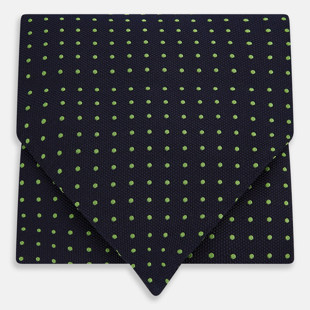 The Green Micro Dot and Navy Silk Cravat by Turnbull & Asser features fine green micro dots on navy silk, adding a refined touch to formalwear. Pair it with a matching pocket square for a cohesive, polished look.
