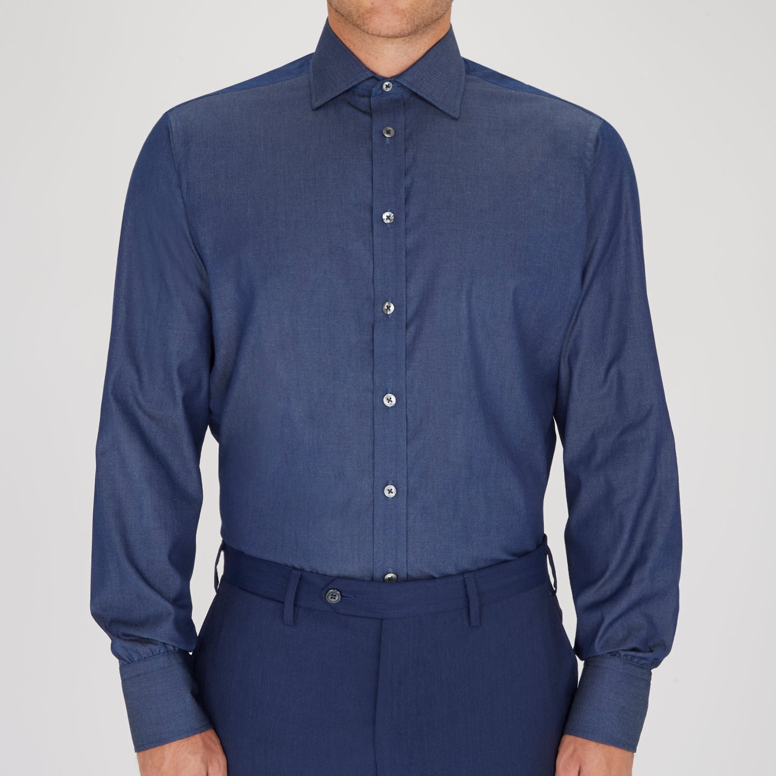 View 2 of product The Turnbull & Asser Dark Blue Denim-Cashmere Shirt features a Regent collar, long sleeves, and 3-button cuffs, neatly folded and displayed on a plain light background.