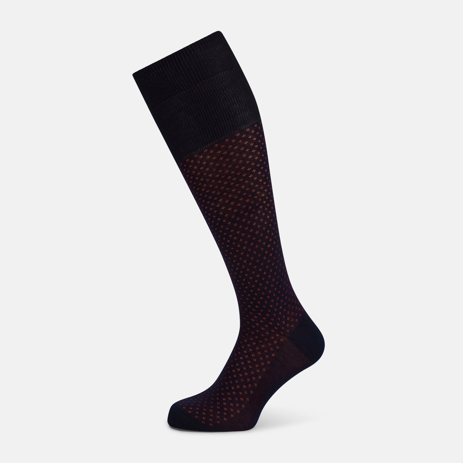 View 1 of product The Turnbull & Asser Navy/Red Motif Long Sock is crafted from mercerised Egyptian cotton, featuring a subtle red and navy diamond pattern with a solid navy cuff, heel, and toe, displayed on a white background.