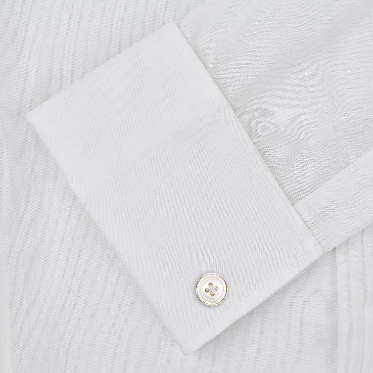 View 4 of product The Die Another Day Inspired Voile Dress Shirt by Turnbull & Asser features a white pleated front, button-down closure, and classic collar—laid flat on white to showcase its timeless James Bond style.