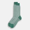 View 2 of product The Turnbull & Asser Ivory Houndstooth Mid-Length Sock features a green and white houndstooth pattern with solid green cuff, heel, and toe accents. Displayed on a plain white background.