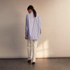 View 10 of product The Turnbull & Asser Pale Blue Candy Stripe Cotton Marlene Shirt is an oversized women's collared shirt with long sleeves, buttoned cuffs, and vertical blue and white stripes, shown laid flat on a white background.