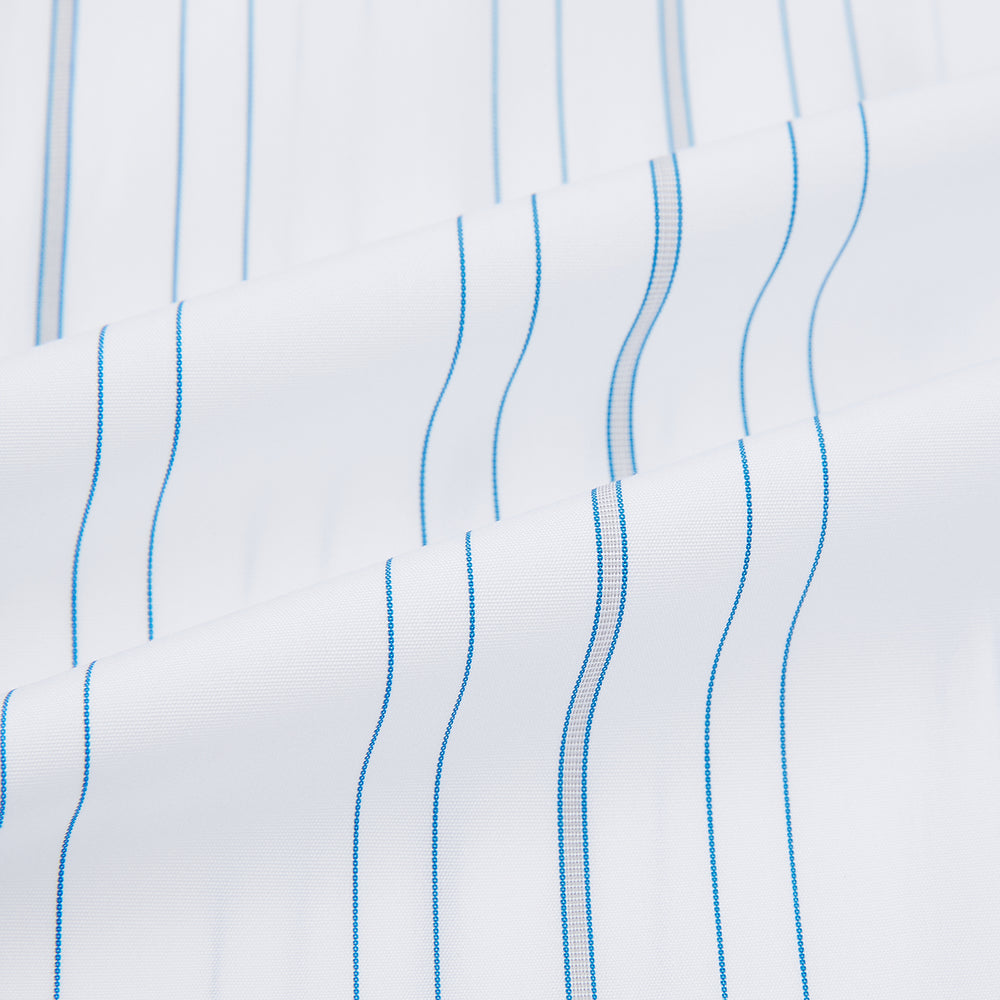 The Turnbull & Asser Pale Blue Multi Stripe Shirt features thin vertical stripes, a contrast collar, and double cuffs, displayed on a plain light background.