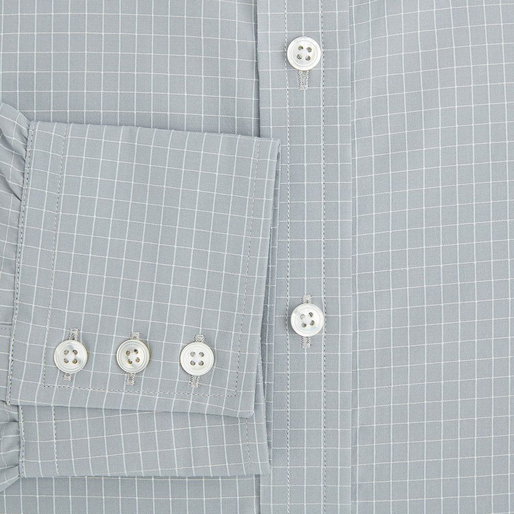 Turnbull & Asser Pale Blue Fine Check Mayfair Shirt—a long-sleeve button-up with classic collar, buttoned cuffs, white buttons, and a subtle check pattern in sanforised cotton—displayed on a white background.