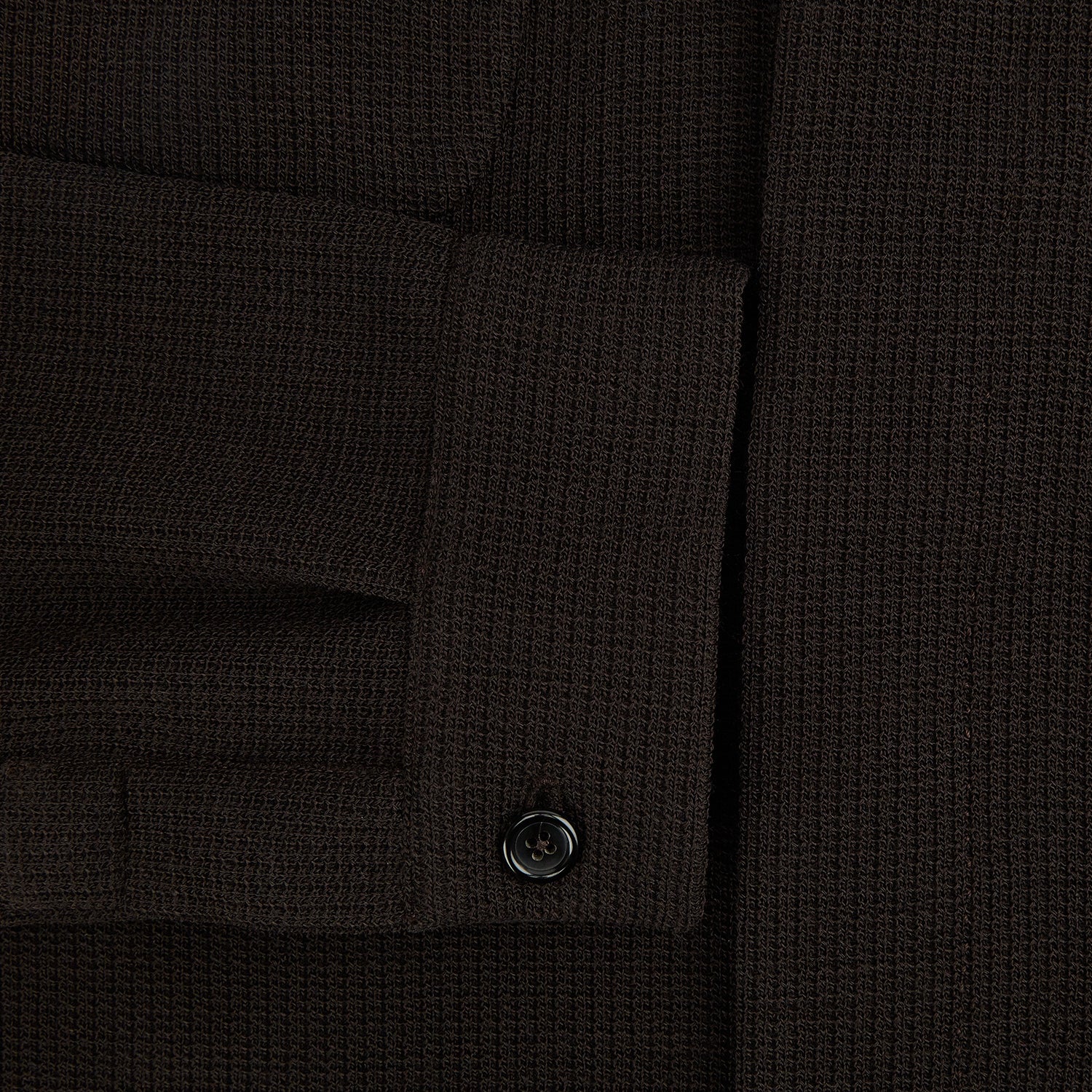 View 4 of product The Turnbull & Asser Dark Chocolate Greenwich Knitted Overshirt is crafted from Italian wool, with a classic collar, two flap chest pockets, and a concealed button front—offering a sleek cardigan alternative. Shown on a white background.