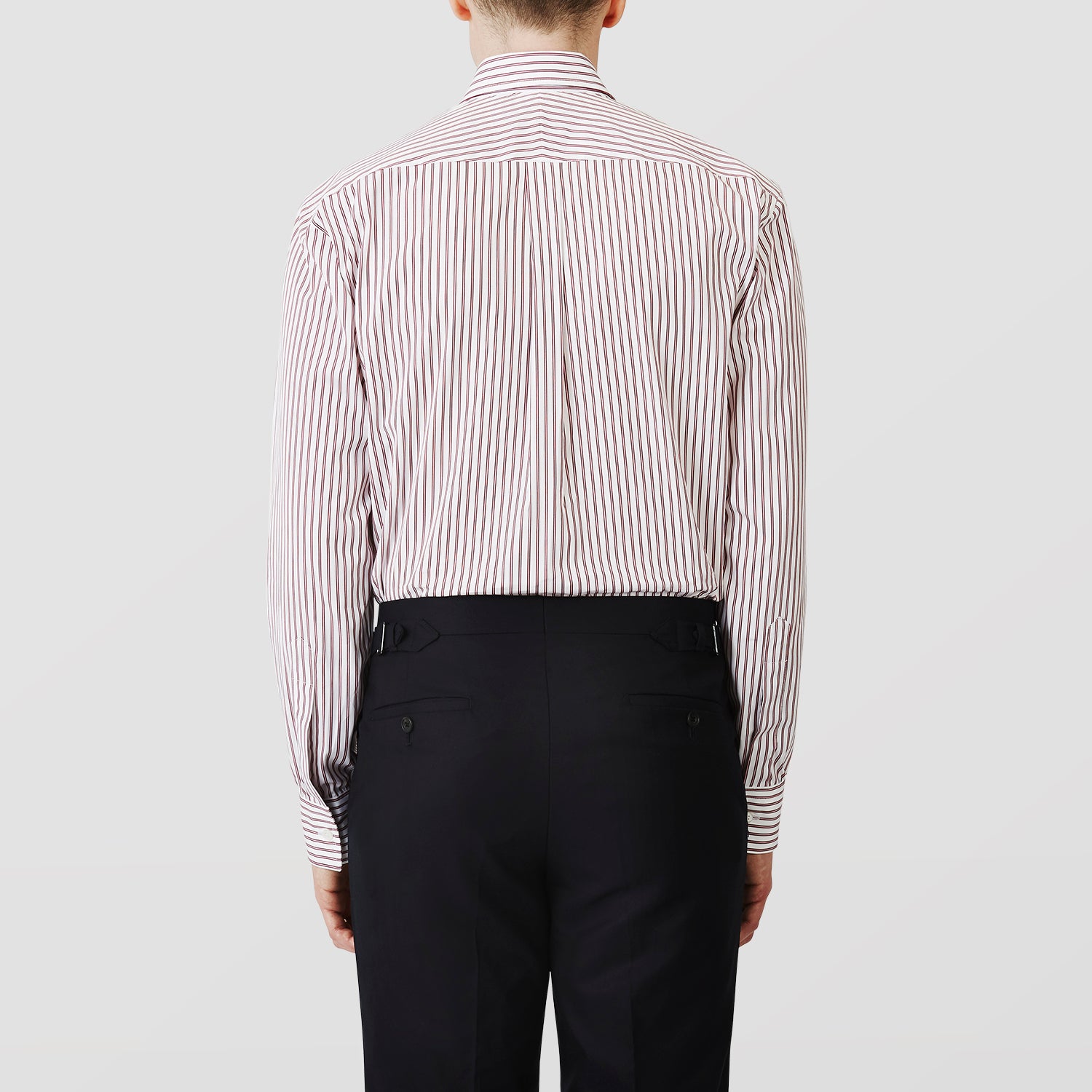 View 3 of product The Turnbull & Asser Burgundy Stripe Weekend Fit Shirt features a Derby collar, 1-button cuffs, and vertical burgundy and white stripes, shown laid flat on a plain light background.