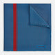 A blue silk pocket square by Turnbull & Asser, featuring thin black stripes, a striking vertical red stripe, and a turned-over corner that reveals the reverse side. The brand name is printed discreetly in one corner.