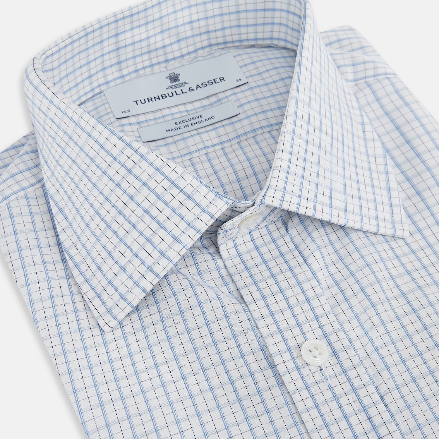 View 2 of product The Turnbull & Asser Sky Blue Combination Graph Check Mayfair Shirt features long sleeves, a pointed collar, buttoned cuffs, and a blue and white check pattern that showcases British craftsmanship. Displayed on a white background.