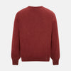 View 3 of product The Turnbull & Asser Crimson Red Cashmere Round Neck Jumper is a classic men’s knitwear piece, featuring long sleeves and a solid crimson hue, shown against a white background.