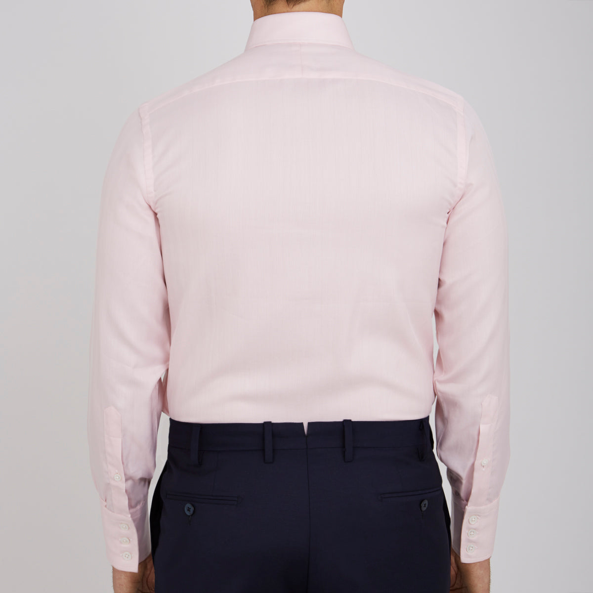 View 3 of product A Pink Herringbone Superfine Cotton Shirt by Turnbull & Asser, featuring a T&A collar and 3-button cuffs, is neatly folded with the inner collar label visible and white buttons, set against a plain white background.